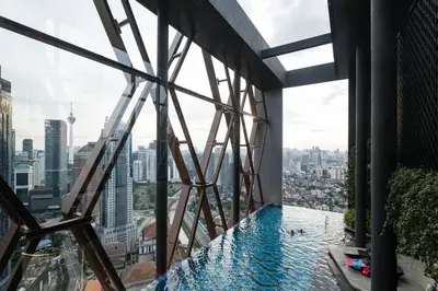 a swimming pool in a building with a view of the city at Scarletz KLCC Studio Suites 4 pax Luxury Modern Style WiFi 100Mbps in Kuala Lumpur