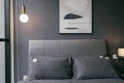a bed with black and white pillows in a bedroom at Scarletz KLCC Studio Suites 4 pax Luxury Modern Style WiFi 100Mbps in Kuala Lumpur