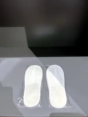 a pair of white shoes sitting on a table at 8 Kia Peng Residence Kuala Lumpur by Scape Stay in Kuala Lumpur