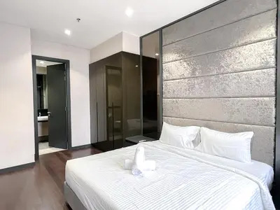 a bedroom with a large white bed with white pillows at 8 Kia Peng Residence Kuala Lumpur by Scape Stay in Kuala Lumpur