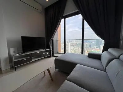 a living room with a couch and a large window at Lucentia Residence BBCC Lalaport at Kuala Lumpur By Luxe Home in Kuala Lumpur