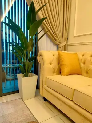 a yellow couch in a living room with a plant at Millerz Suite 3R2B Condo Near MidValley 3 Beds 3 Bedrooms Staycation Best Choice in Kuala Lumpur
