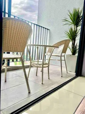 two chairs and a table on a balcony at Millerz Suite 3R2B Condo Near MidValley 3 Beds 3 Bedrooms Staycation Best Choice in Kuala Lumpur