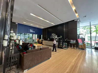 a lobby with a person walking in a store at One Bukit Ceylon by Home Suites in Kuala Lumpur