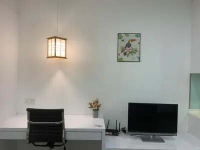 a computer desk with a monitor and a chair at RS Suites In Bukit Bintang in Kuala Lumpur