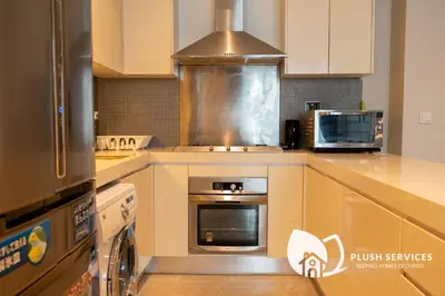 a kitchen with a stove top oven and a microwave at Fairlane Residences by Plush in Kuala Lumpur