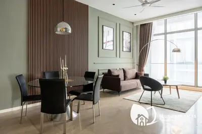 a living room with a couch and a table and chairs at Fairlane Residences by Plush in Kuala Lumpur