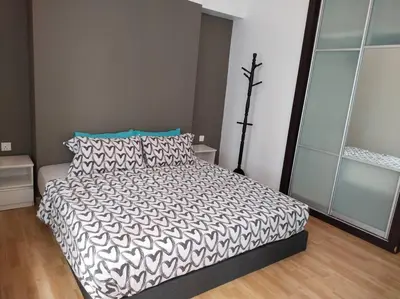 a bedroom with a bed with a black and white comforter at The Orion @Next to IJN 3 Bedroom Unit in Kuala Lumpur
