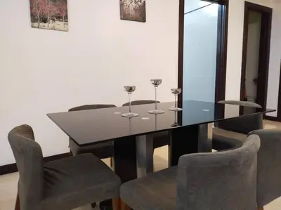 a dining room with a glass table and chairs at The Orion @Next to IJN 3 Bedroom Unit in Kuala Lumpur