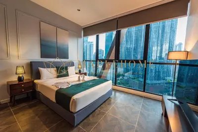 a bedroom with a bed and a large window at Scarletz Premier Suites Kuala Lumpur in Kuala Lumpur