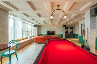 a living room with a large red pool table at Scarletz Premier Suites Kuala Lumpur in Kuala Lumpur