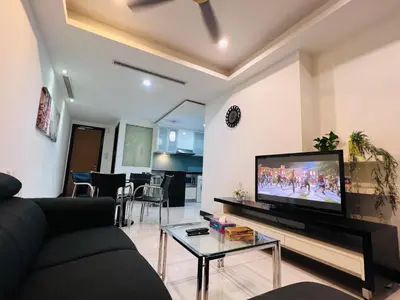 a living room with a couch and a flat screen tv at CozyHome Suites @ Casa Residency in Kuala Lumpur