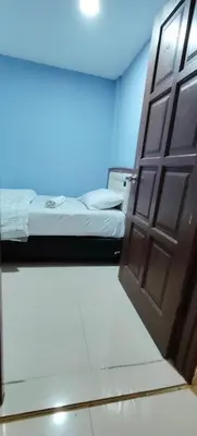 a door leading to a bed in a room at RAS International Hotel in Kuala Lumpur
