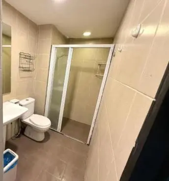 a bathroom with a shower and a toilet and a sink at Taragon Homestay - Kuala Lumpur, Malaysia in Kuala Lumpur
