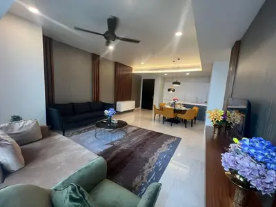 a living room with a couch and a table at Tropicana The Residence KLCC By Rainbow Suites in Kuala Lumpur
