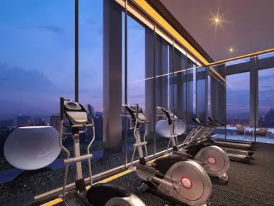 a gym with a view of the city at night at Tropicana The Residence KLCC By Rainbow Suites in Kuala Lumpur