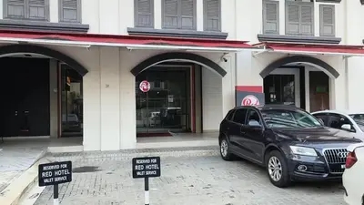a black car parked in front of a building at The RED in Kuala Lumpur