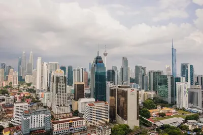 a view of a city with tall buildings at NaiBnB in Regalia Residence in Kuala Lumpur