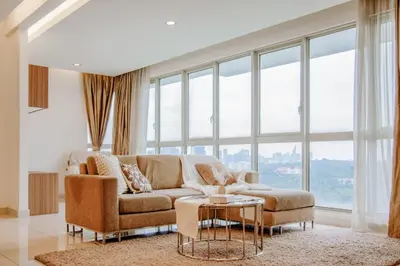 a living room with a couch and a table at NaiBnB in Regalia Residence in Kuala Lumpur