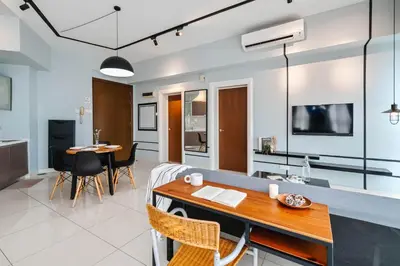 a living room and dining room with a dining table at NaiBnB in Regalia Residence in Kuala Lumpur