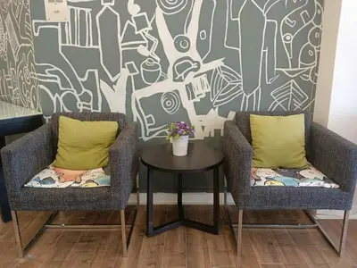 two chairs and a table in front of a wall at Fahrenheit 88 Suites Bukit Bintang H 3R in Kuala Lumpur