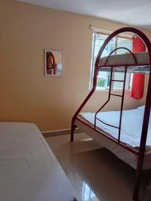 a bedroom with two bunk beds and a mirror at RAS Hotel in Kuala Lumpur