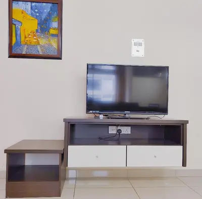 a flat screen tv sitting on top of a entertainment center at AJ-HOME Fahrenheit 88 Pavillion Bukit Bintang 8pax in Kuala Lumpur