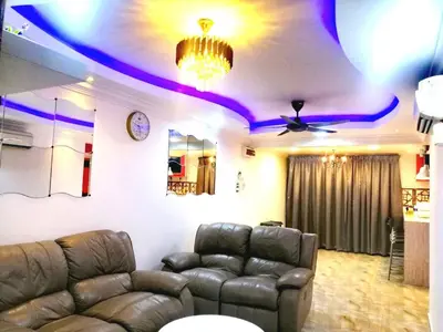 a living room with a couch and a ceiling with purple lights at Apartment Low Cost 2 Bilik Asnor Homestay KL in Kuala Lumpur