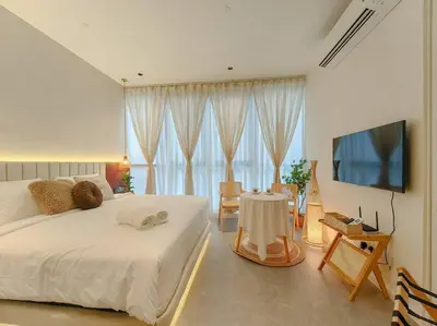 a bedroom with a bed and a television and a table at Scarletz Suites by Stevvy KL Home Stay in Kuala Lumpur