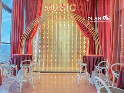 a room with chairs and a stage with red curtains at Scarletz Suites by Stevvy KL Home Stay in Kuala Lumpur