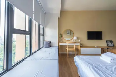 a bedroom with a bed and a desk with a tv at KLCC SkyTowerViewSuite AT CeylonzSuites in Kuala Lumpur