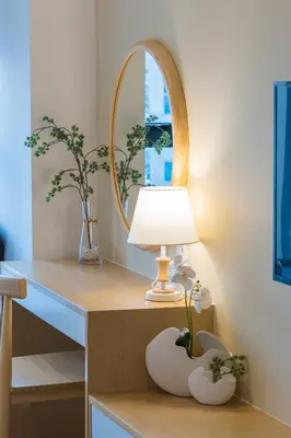 a table with a lamp and a mirror on it at KLCC SkyTowerViewSuite AT CeylonzSuites in Kuala Lumpur