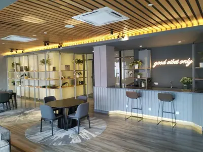 a lobby with a table and chairs and a bar at KLCC SkyTowerViewSuite AT CeylonzSuites in Kuala Lumpur