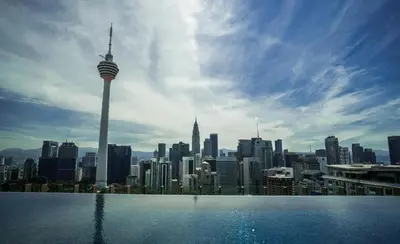 a view of a city skyline from a swimming pool at KLCC SkyTowerViewSuite AT CeylonzSuites in Kuala Lumpur