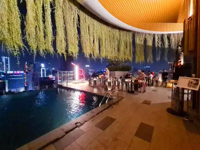 a hotel lobby with a swimming pool and a city skyline at Romantic Log Cabin - walk to KL Tower, KLCC, Bukit Bintang in Kuala Lumpur