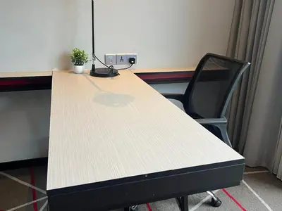 an office desk with a plant sitting on top of it at ComfyHomes M101 Dang Wangi Pool KLCC View in Kuala Lumpur