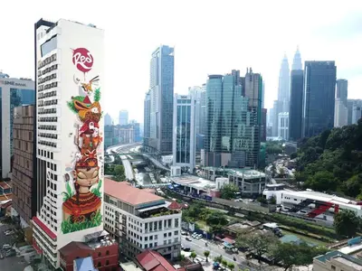 a city with a tall building with a sign on it at ComfyHomes M101 Dang Wangi Pool KLCC View in Kuala Lumpur