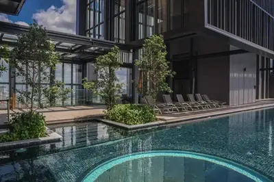 an external view of a building with a swimming pool at Maxhome Plus at Lucentia Bukit Bintang City centre KL in Kuala Lumpur