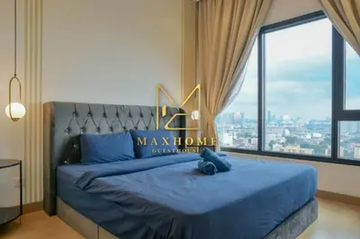 a bedroom with a blue bed with a large window at Maxhome Plus at Lucentia Bukit Bintang City centre KL in Kuala Lumpur