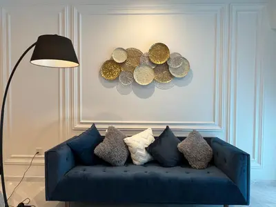 a blue couch in a living room with a lamp at Eaton Residences KLCC by WSD in Kuala Lumpur