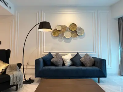 a blue couch in a living room with a lamp at Eaton Residences KLCC by WSD in Kuala Lumpur