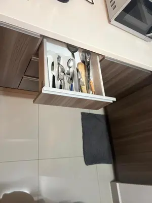 a kitchen cupboard with utensils in it at Regalia Modern Studio in Kuala Lumpur