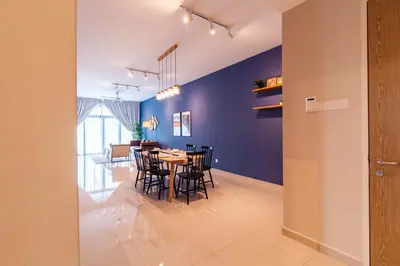 a dining room with blue walls and a table and chairs at Legasi @ Kampung Bharu in Kuala Lumpur