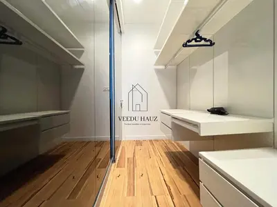 a kitchen with white counters and a wooden floor at The Platinum KLCC by Veedu Hauz in Kuala Lumpur