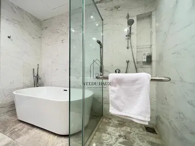 a bathroom with a tub and a glass shower at The Platinum KLCC by Veedu Hauz in Kuala Lumpur