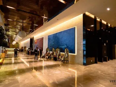 a lobby with chairs and a large painting on the wall at The Platinum KLCC by Veedu Hauz in Kuala Lumpur