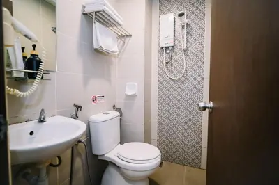 a bathroom with a toilet and a sink at Swing & Pillows - Dataran Merdeka Kuala Lumpur in Kuala Lumpur