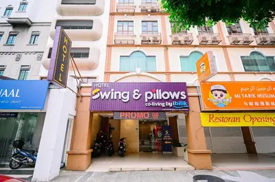 a building with many signs in front of it at Swing & Pillows - Dataran Merdeka Kuala Lumpur in Kuala Lumpur