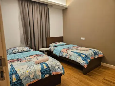 a bedroom with two beds and a window at The Wisdom Apartment in Kuala Lumpur
