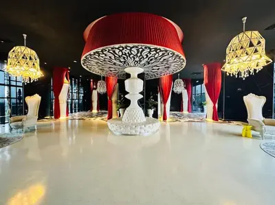 a table topped with a red and white table centerpiece at Diamond Home Comfort @ Arte Mont Kiara in Kuala Lumpur